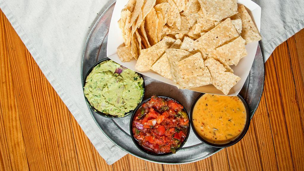 Triple Threat · Salsa, queso, and guacamole with chips to dip, enough to share.