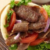 Beef-Licious Shawarma Wrap · Roasted layers of beef marinated with herbs and spices, with pickles, lettuce , tomato, onio...