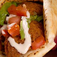 Falafel Wrap · Crispy falafel balls made from ground chickpeas and fava beans, with lettuce, tomato, pickle...
