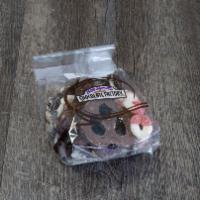 Chocolate Snack Bag · Pretzel and oreo pieces drizzled with milk chocolate and white confection with assorted gumm...