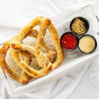 Twisted Dough · Our version of pretzel, sea salt, Parmesan, beer cheese, pie sauce, whole grain mustard.