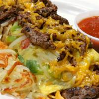 Steak Omelet · Strips of top sirloin steak, grilled onions, peppers, and cheddar cheese folded in a three e...