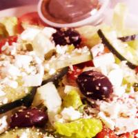 Greek Salad · Romaine lettuce, cucumbers, olives, feta cheese, tomatoes, onions, oregano leaves, and Greek...