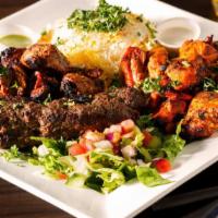 Kabob Gyro Platter · Fresh sliced kabob gyro over yellow rice and topped with famous white garlic sauce. Comes wi...
