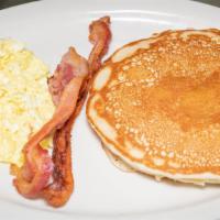 Pancake Breakfast · A short stack of pancakes served with two eggs, any style, and your choice of bacon or sausa...