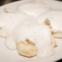 Biscuit & Gravy · Two homemade buttermilk biscuits split and covered with cream gravy mixed with pork sausage.