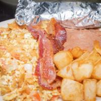 Migas Plate · Corn tortillas, tomatoes and onions scrambled with eggs and served with beans, potatoes, two...
