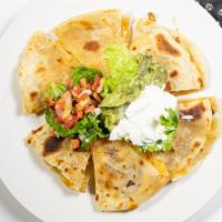 Quesadillas · Four Flour Tortillas stuffed with beef or chicken fajita, or grilled vegetables and Monterey...