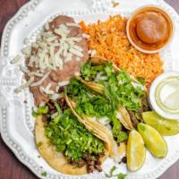 Tacos Al Carbon · 3 - Grilled tacos with choice of one meat topped with diced onions and cilantro. This platte...