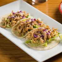 Tacos De Pollo · Two chicken tacos with coleslaw, cheese and salsa.