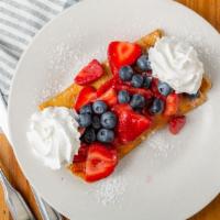 Queen'S Berries And Cream Crepe · Freshly made crepe topped with strawberries and blueberries smothered with sweet cream garni...