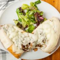 Philly Cheesesteak · Shaved Philly steak sautéed and topped with melted mozzarella cheese, green peppers, mushroo...