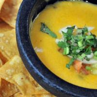 Chile Con Queso · Gluten free. Melted potato based cheese served with gf corn tortilla chips. Diced tomato, ja...