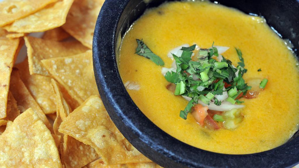 Chile Con Queso · Gluten free. Melted potato based cheese served with gf corn tortilla chips. Diced tomato, jalapeno, and onion served on the side.
