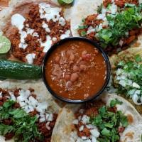 Taco Platter - Gf Corn Tortilla · Your choice of five tacos on gluten free corn. Comes with a side of charro beans pinto and o...