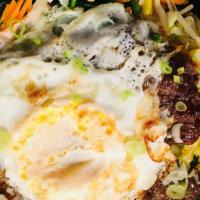 Hot Stone Bowl Bibimbab · Variety vegetables and rice served in a hot stone bowl topped with a fried egg and Korean sp...
