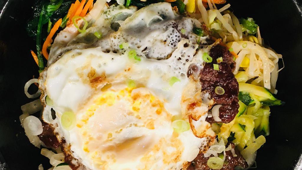 Hot Stone Bowl Bibimbab · Variety vegetables and rice served in a hot stone bowl topped with a fried egg and Korean spicy sauce.