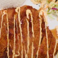 Tonkatsu · Deep-fried pork cutlet served with steamed rice, shredded cabbage mix, and tonkatsu sauce.