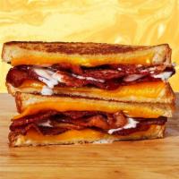 Bacon Cheddar Ranch Grilled Cheese · Melted cheddar, crisp bacon, and ranch dressing between two slices of buttery grilled bread.