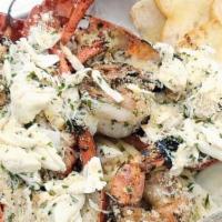 Lobster Tchoupitoulas · Whole grilled lobster with clams, shrimp, lump crab meat and linguini topped with garlic but...