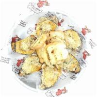 Chargrilled Oysters · Gulf oysters loaded with garlic butter and parmesan cheese