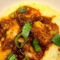 Shrimp And Grits · Creamy yellow grits topped with shrimp, trinity sauce and green onions