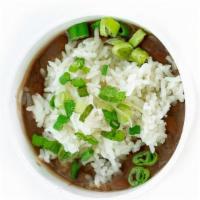 Red Beans & Rice · Red Beans, sausage and ham topped with steamed white rice and green onion