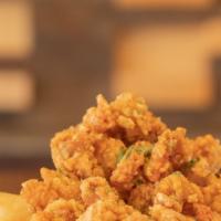 Popcorn Chicken · Seasoned, fried and crispy popcorn chicken served with straight-cut fries and sauce. Mix up ...