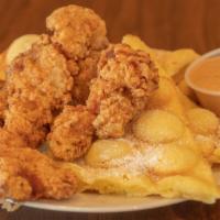 Chicken And Waffle · Crispy chicken tenders with wafflepuff dusted with powdered sugar. Comes with house sauce an...
