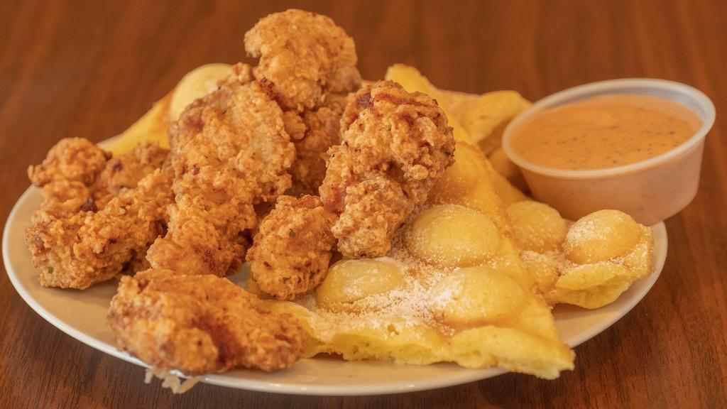 Chicken And Waffle · Crispy chicken tenders with wafflepuff dusted with powdered sugar. Comes with house sauce and syrup. Add more sauce or syrup for an upcharge.