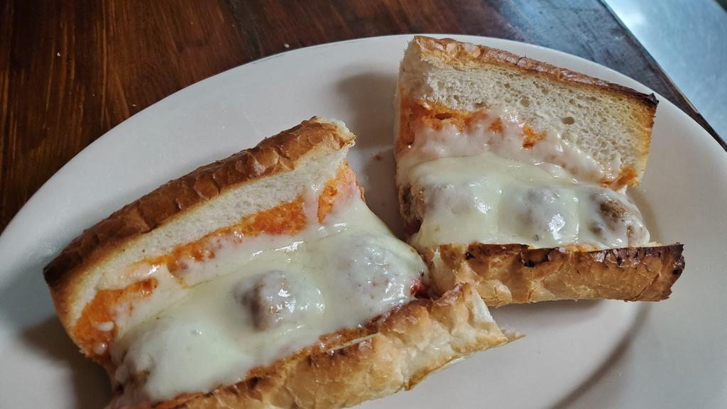 Chicken Parmigiana · Breaded chicken breast smothered in marinara sauce and covered with mozzarella cheese on an 11 '' French bread.