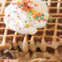 Fruity Pebbles Waffles · Fruity pebbles waffle mix, topped with fresh blueberries and strawberries, dusted with powde...