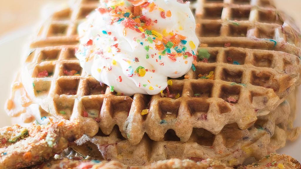 Fruity Pebbles Waffles · Fruity pebbles waffle mix, topped with fresh blueberries and strawberries, dusted with powdered sugar, whipped cream.