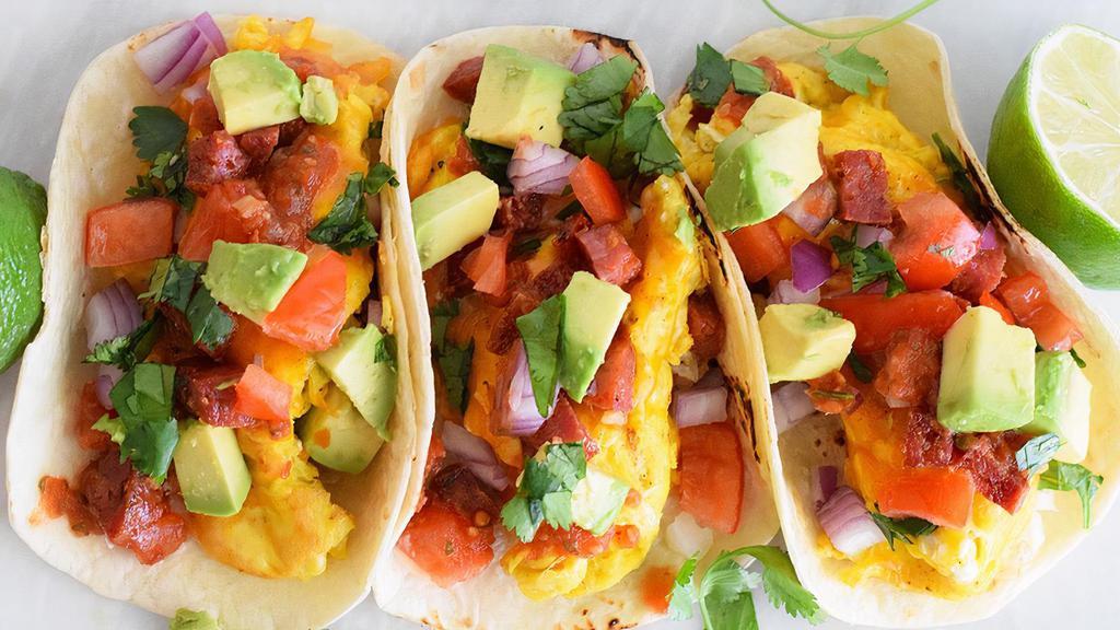 Breakfast Tacos (3) · Bacon, egg and cheese or potato, egg and cheese breakfast tacos, served with sofrito black beans and salsa.