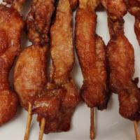 Cho Cho Chicken (6) · Skewered chicken strips on a stick.