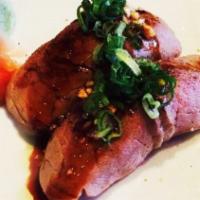 Sakezura Sushi · Seared salmon, quail egg, eel sauce and radish sprout.