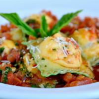 Four Cheese Ravioli · Homemade ravioli stuffed with Reggiano, Manchego, Fontina, and ricotta cheeses, tossed in Ti...