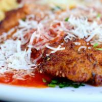 Chicken Parmesan · Served with fedelini and our homemade marinara sauce.