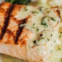 Grilled Norwegian Salmon · Served over a bed of Parmesan risotto in a light cream pesto sauce.