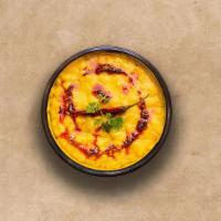 Yellow Lentils  · Slow-cooked lentils tempered with herbs and whole red chillies.