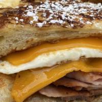 Back To Bed Sandwich · Two eggs over easy, ham, sausage, bacon and cheddar cheese drizzled with maple syrup.  Serve...