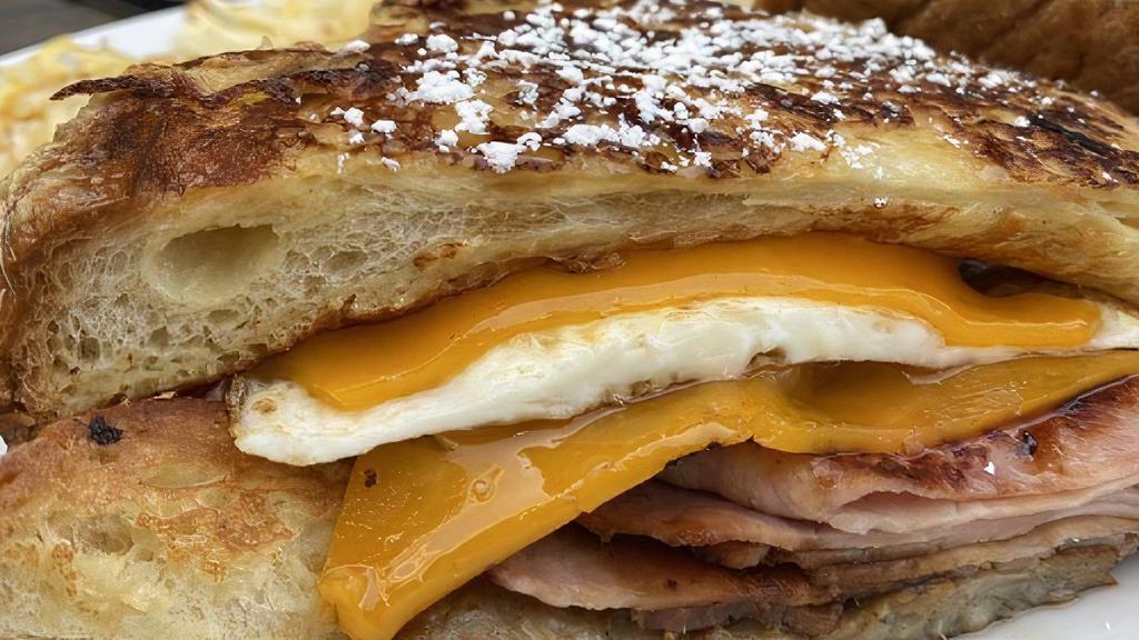 Back To Bed Sandwich · Two eggs over easy, ham, sausage, bacon and cheddar cheese drizzled with maple syrup.  Served on a french toast bun.