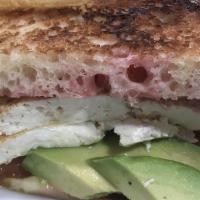 Vegan Breakfast Sandwich · Marinated tofu, avocado, tomato and vegan sauce between two vegan english muffins.