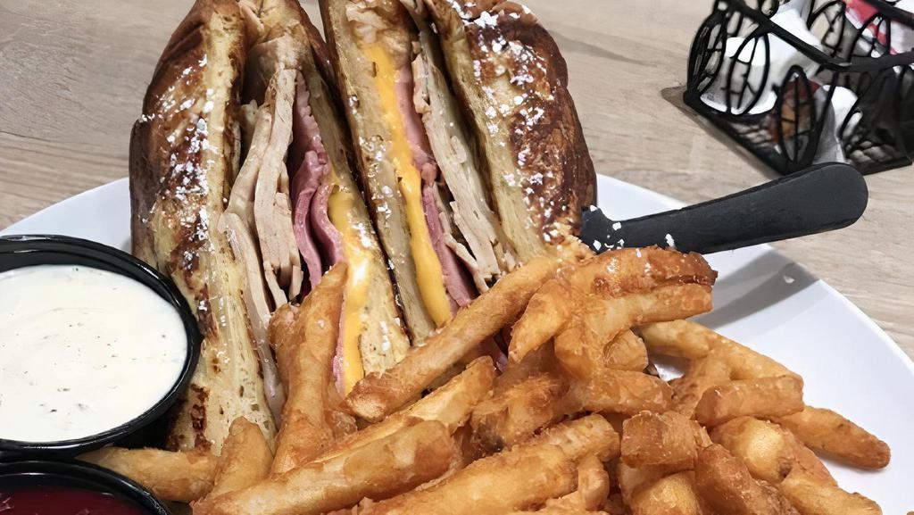 Monte Cristo · Fresh sliced ham and turkey, served with swiss and American cheeses then battered and fried to a golden brown. Served with raspberry preserves for dipping and dusted with powdered sugar.