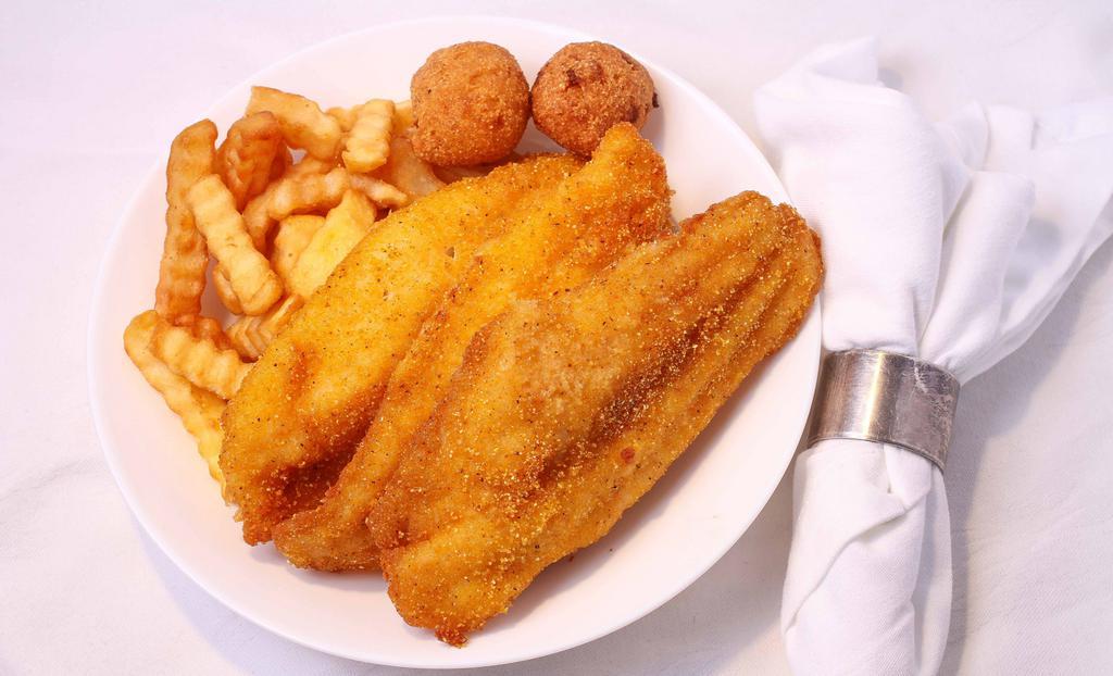 Catfish · 3 pieces of catfish with fries and hushpuppies.