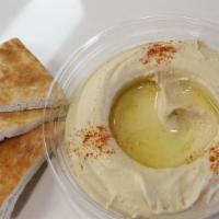 Hummus Dip · Vegan. Your choice of regular or spicy freshly made hummus topped with paprika and olive oil...
