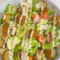 Falafel Salad · Vegan. Lettuce, cucumbers, parsley, radish, green onions, and tomatoes, all mixed with lemon...
