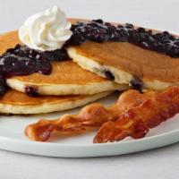 Double Blueberry Pancakes · Three buttermilk pancakes with blueberries, topped with blueberry sauce and whipped cream. S...