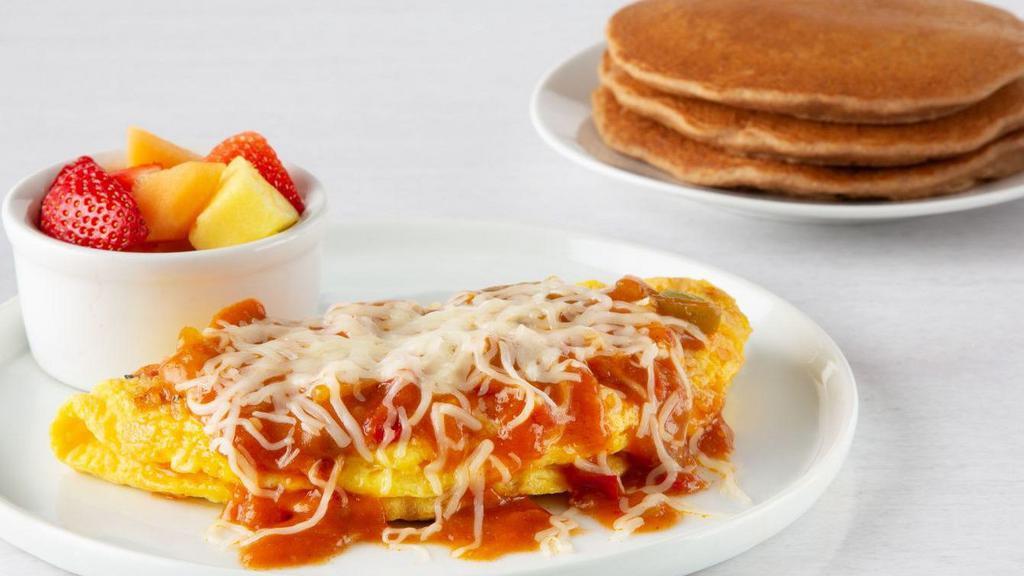 Veggie Omelette · Low-cholesterol egg substitute, onions, green peppers, tomatoes, and mushrooms. Topped with Spanish sauce and mozzarella cheese. Served with only fresh fruit and multigrain pancakes. Hash browns not included.