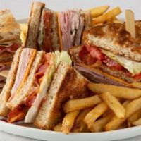 Double Decker Club · Hand-carved turkey breast, ham, cherrywood-smoked bacon and American cheese with tomato, let...